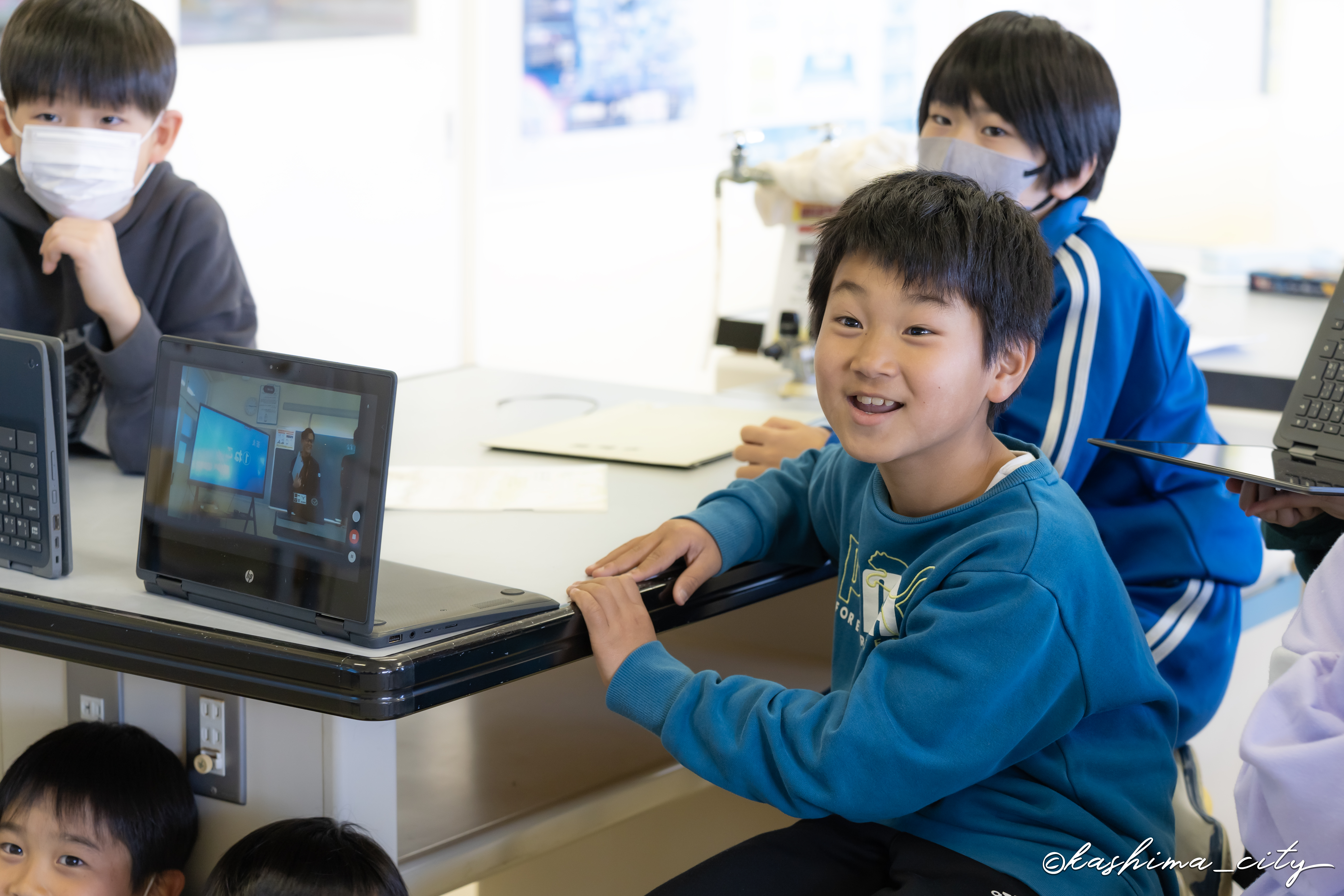 職員の話に興味津々な男子児童